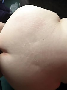 Naked older woman standing on the street