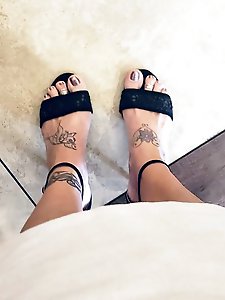 A well-endowed older woman is pleasuring herself